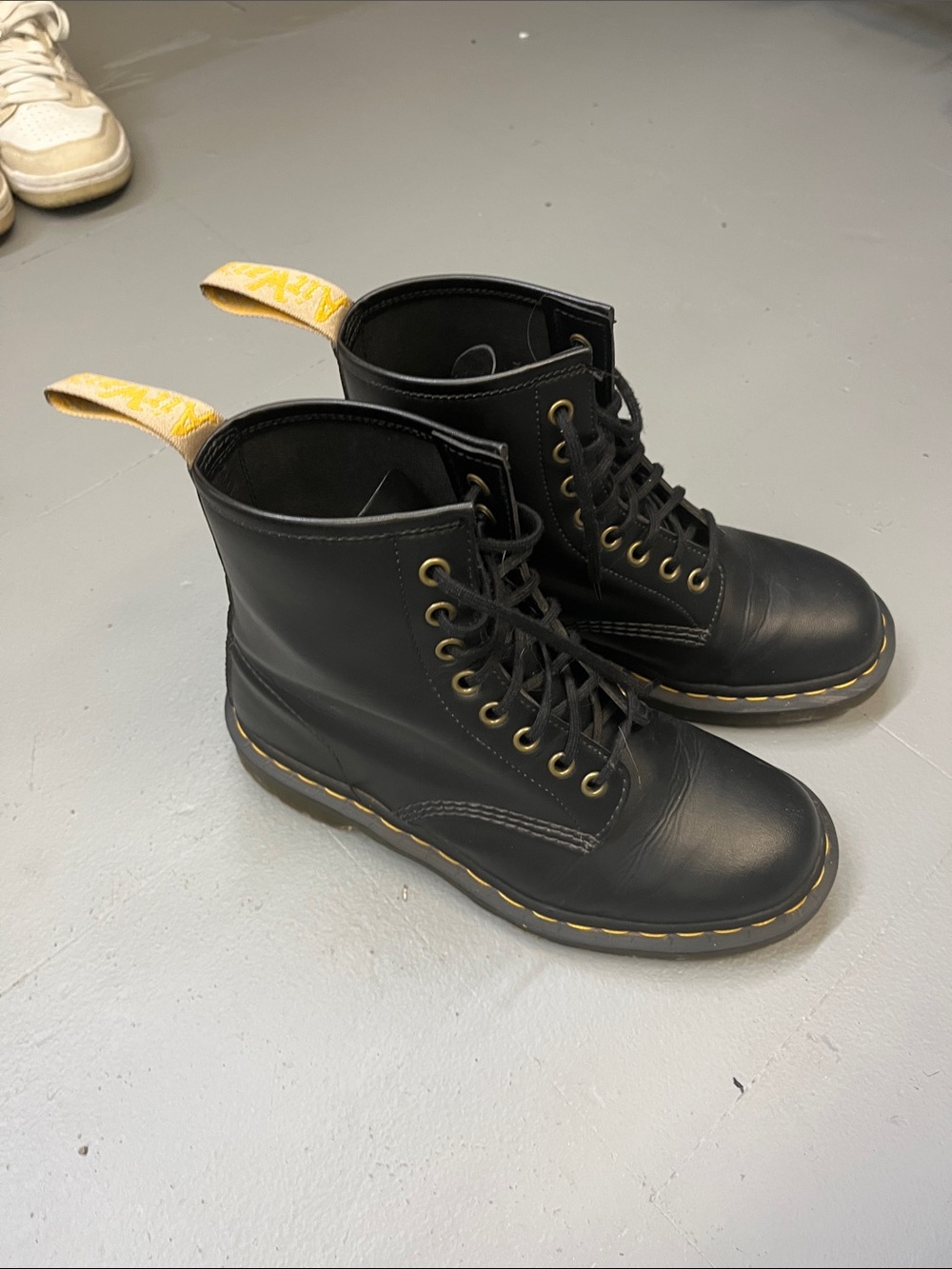 Dr. Martens Black Leather Lace-Up Boots with Yellow Pull Tab and Welt Stitching